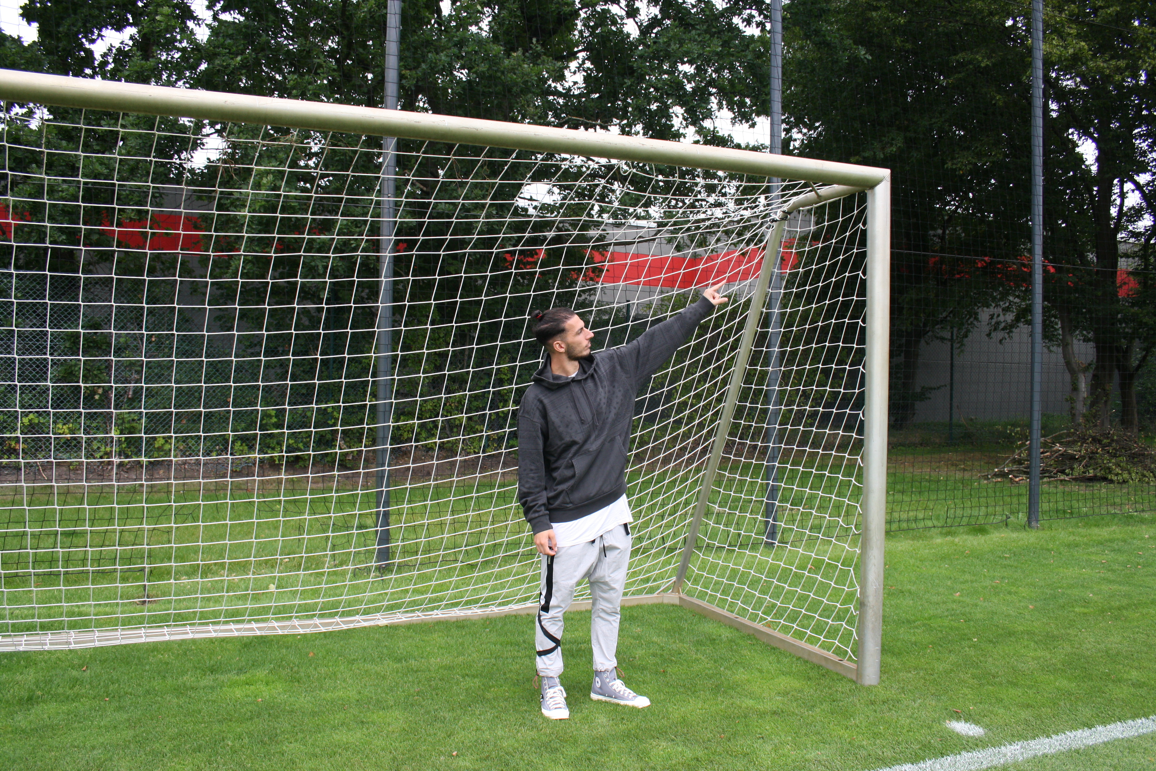 Leart Paqarada points to where the ball entered the Kiel net: bang in the top-right corner.