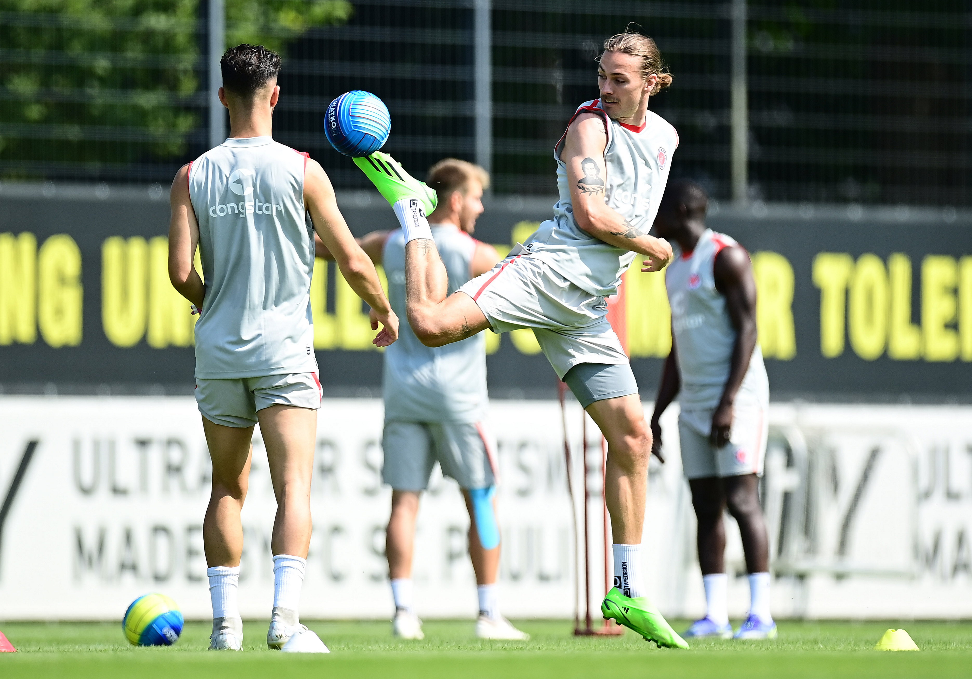 A moment of acrobatics from Jackson Irvine during Tuesday morning’s training session – under the watchful eye of Leart Paqarada (left).