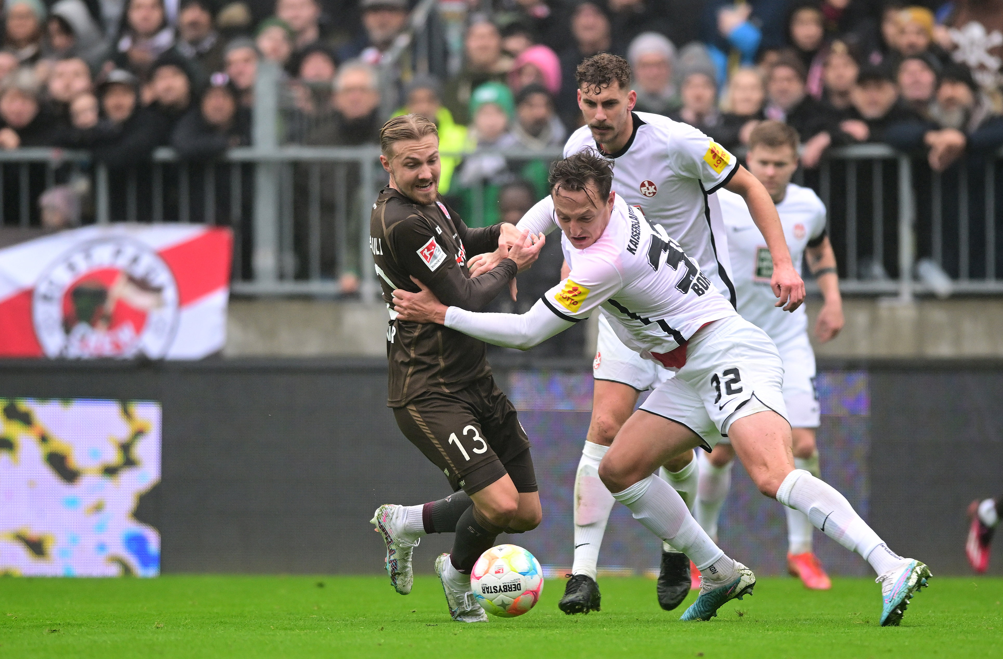 Lukas Daschner under challenge from three Kaiserslautern players.