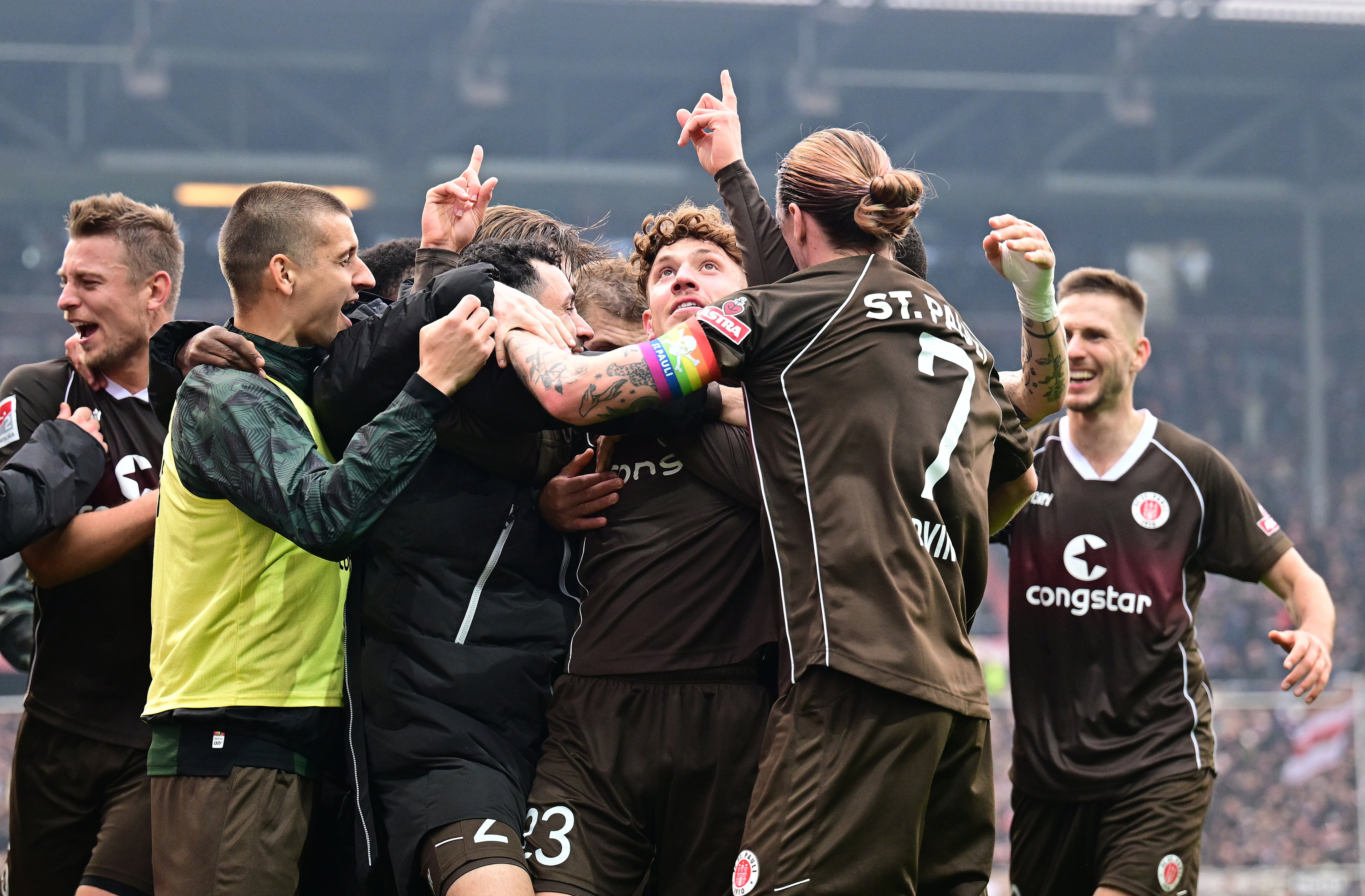 Philipp Treu is mobbed after scoring the winner in the 2-1 defeat of Karlsruhe